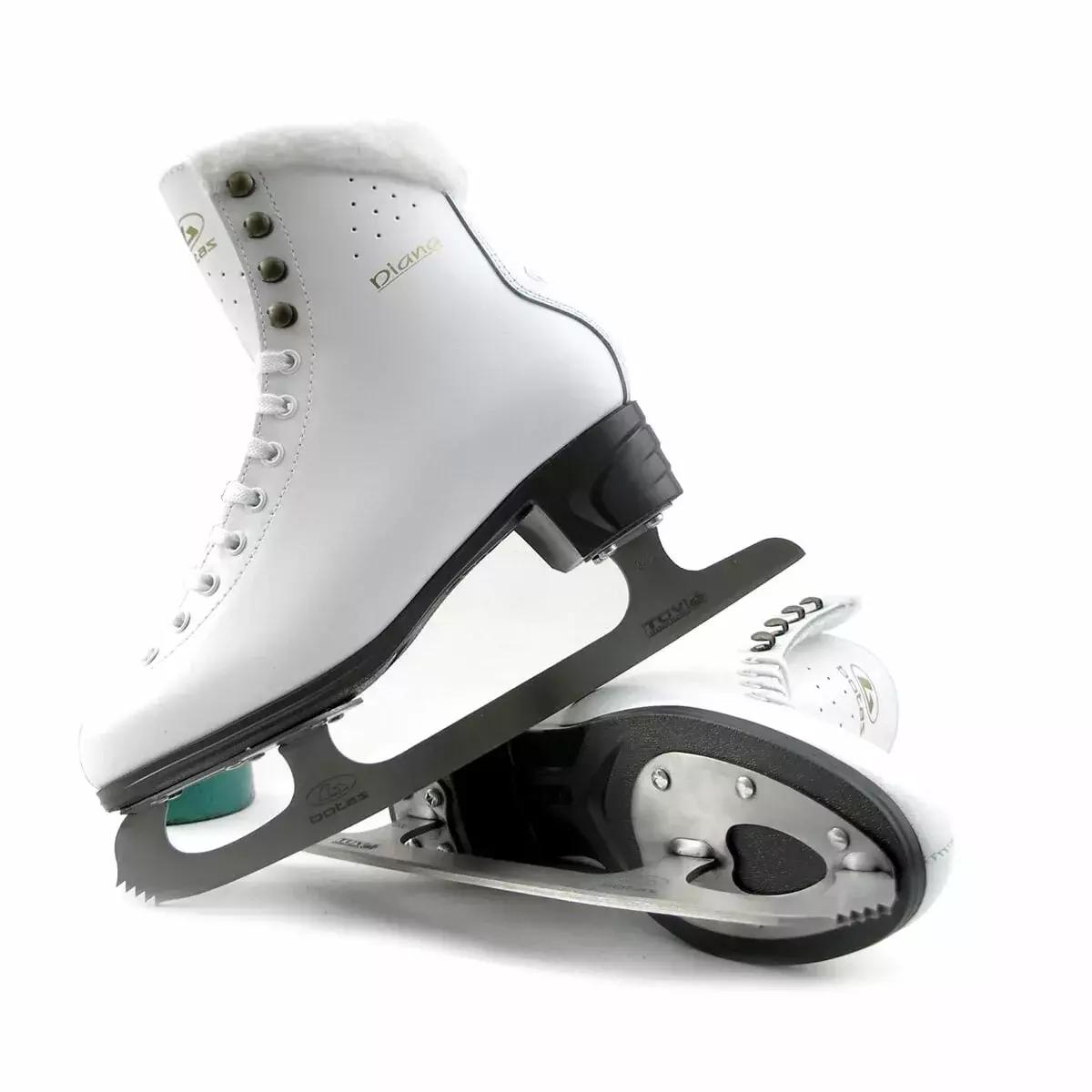 Pair of Botas Diana figure skates stacked, showing the graphite sole, heel plate and toe pick of the Botas blade