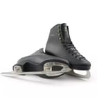 Pair of Botas Robin black figure skates, one on its side showing the screw-mounted blade