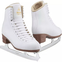 Jackson Ultima Artiste JS1790 figure skates, pair: white boots with tan padded topline, gold Jackson Artiste tongue logo, brown PVC heels and chrome Ultima Mark IV blades
